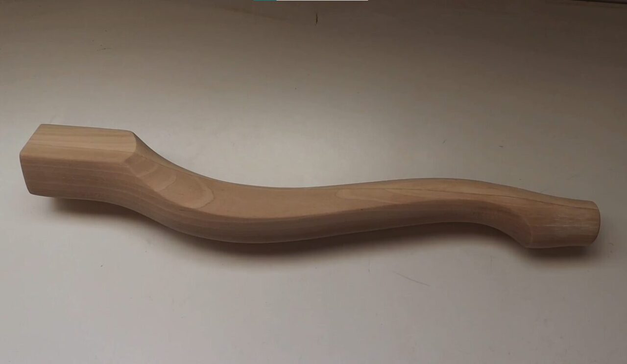 Chippendale-style furniture leg showcasing curved, intricate design.