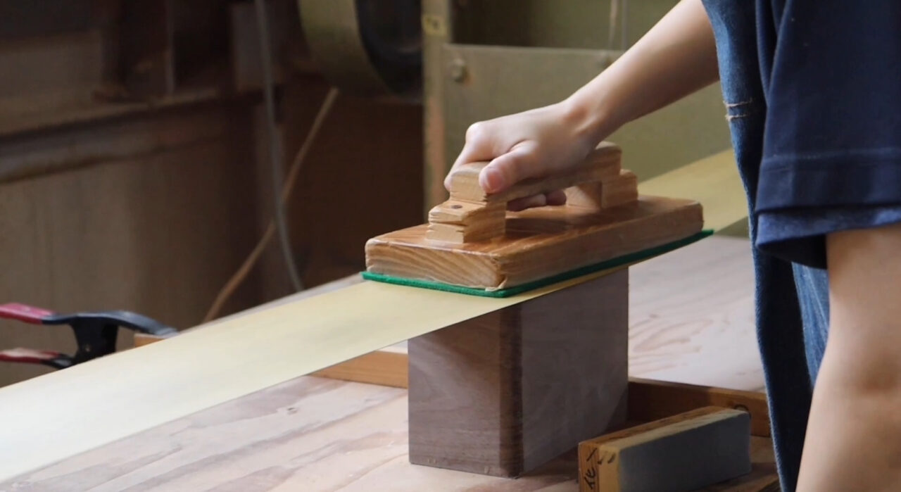 Sanding process with a belt sander to reveal wood grain