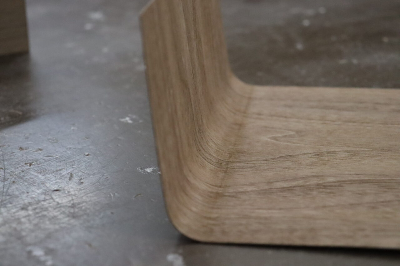 Veneer bending process: Wet veneer is heated and bent to conform to the shape of a component.