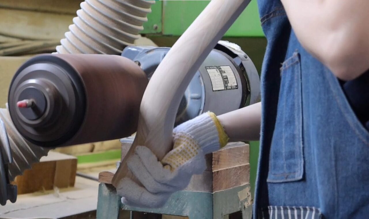 Spindle sander used for finishing the surface, demonstrating the application of different grit sandpapers for multiple sanding passes.
